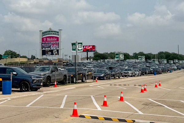 Front parking lot full of cars with State Fair Park T Mobile sign
