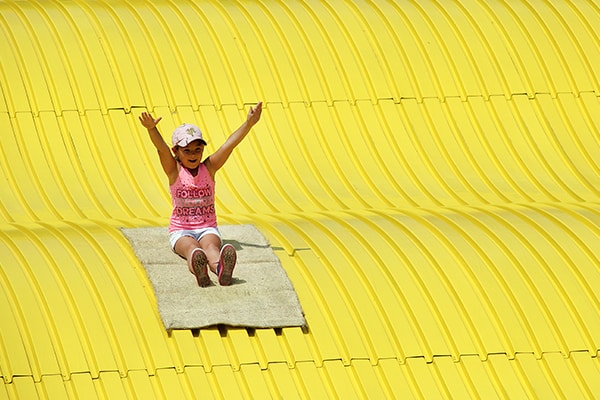 Girl Enjoying Trip Down Giant Slide