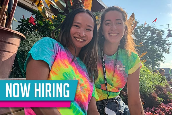 Now Hiring - two seasonal staff members in bright tie dye Wisconsin State Fair shirts